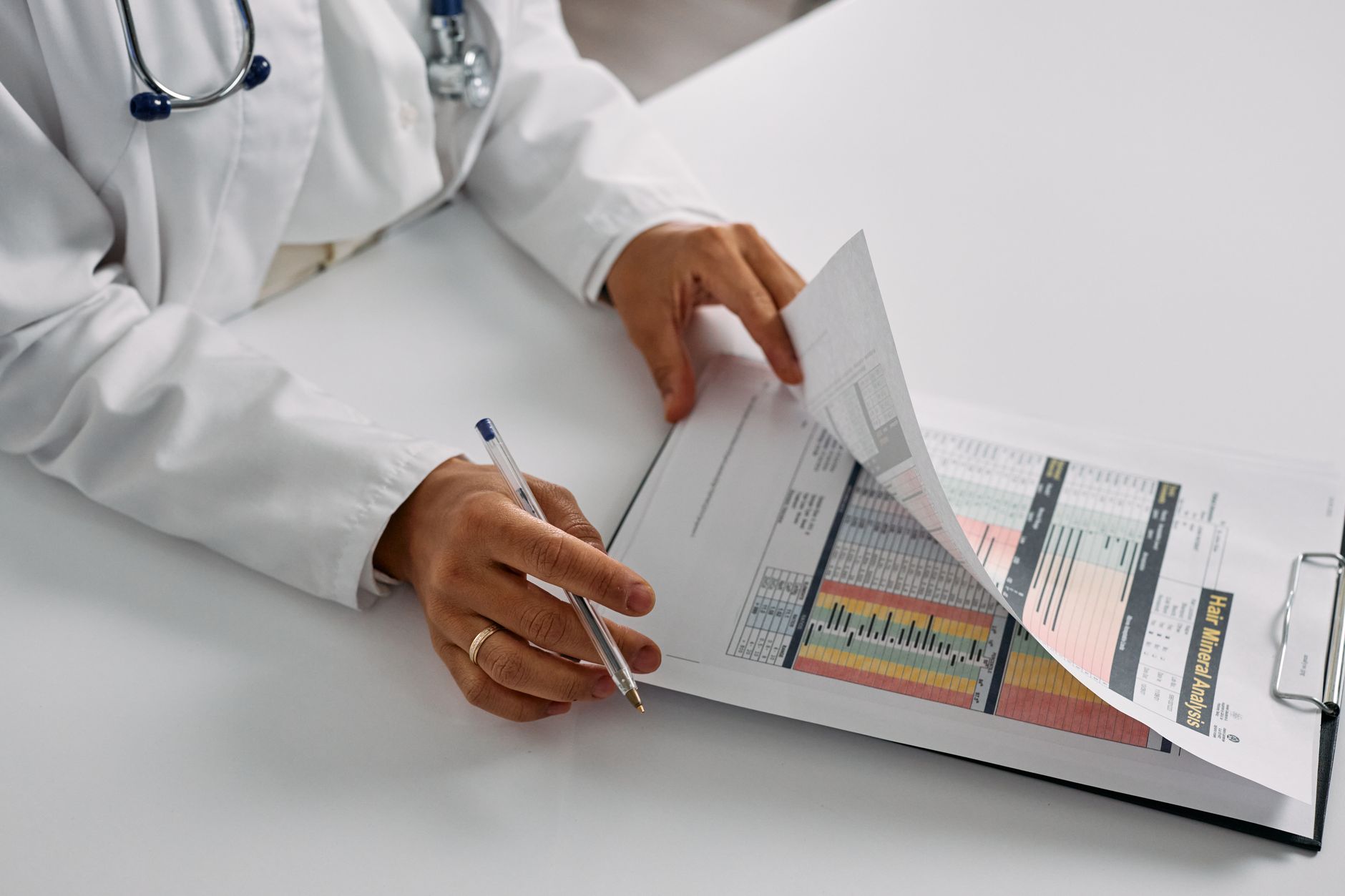 A healthcare compliance officer reviewing a security policy pack at a desk